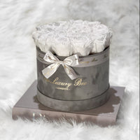white preserved infinity roses in grey velvet box