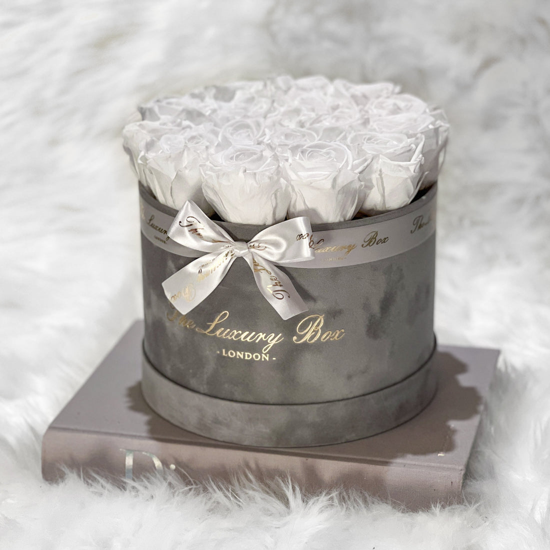 white eternity roses in grey velvet box