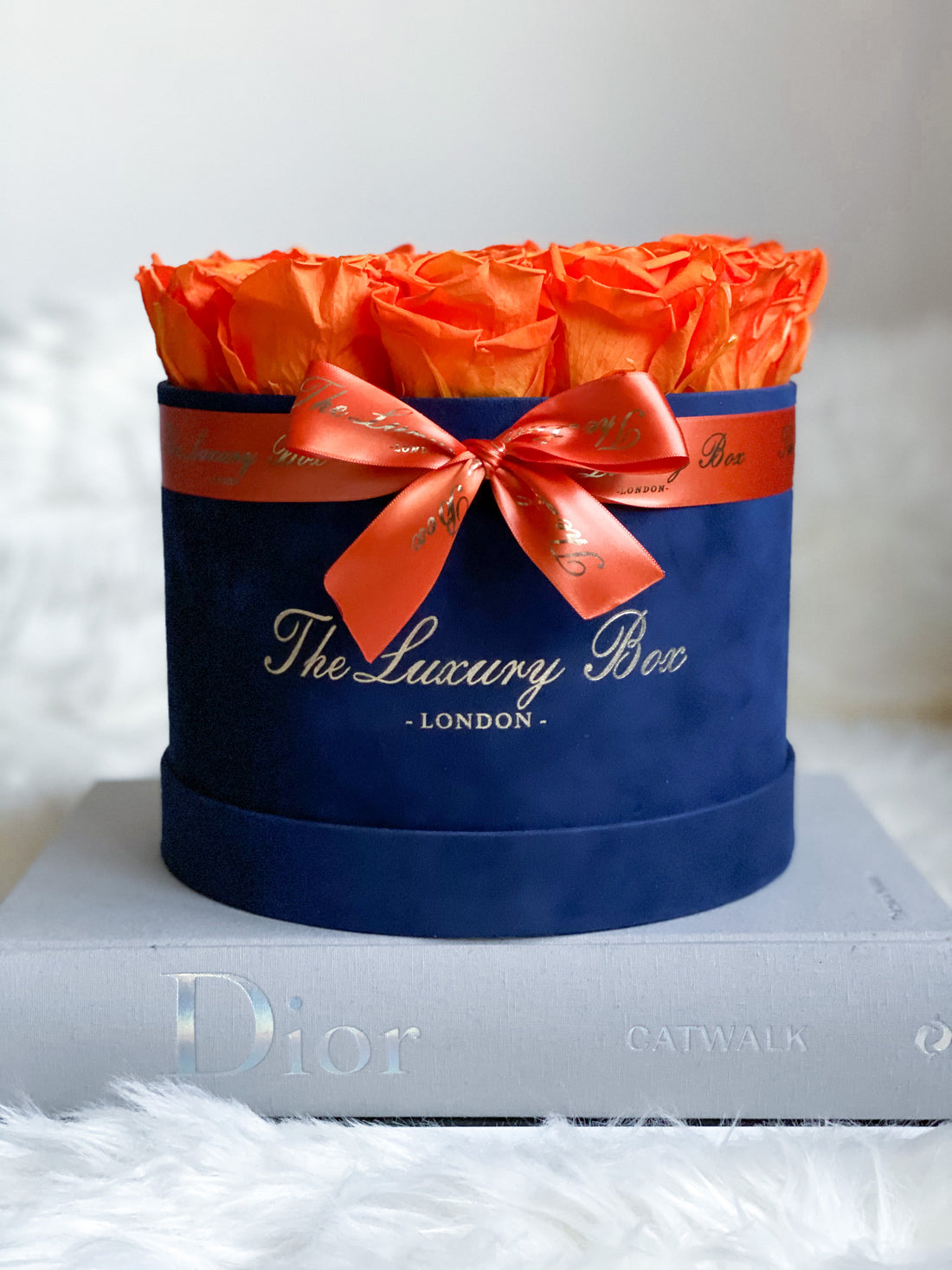 orange preserved eternity roses in velvet navy blue box