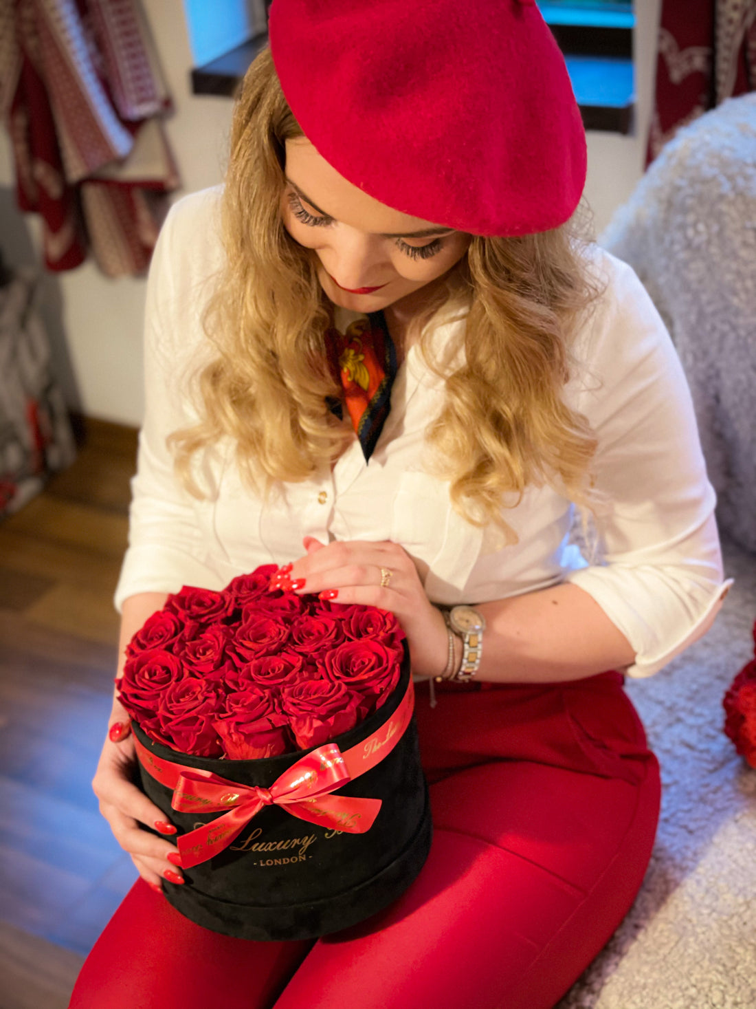 woman with valentine's day gift red infinity roses in box